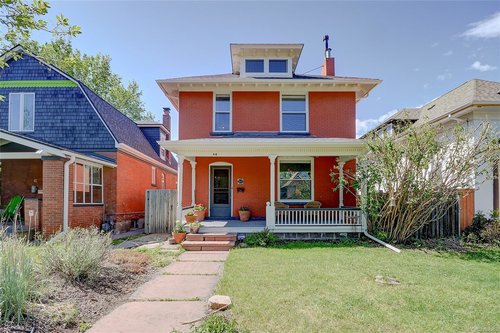Classic Denver Square home with brick exterior, large front porch, and tree-lined street in a historic Denver neighborhood near downtown.